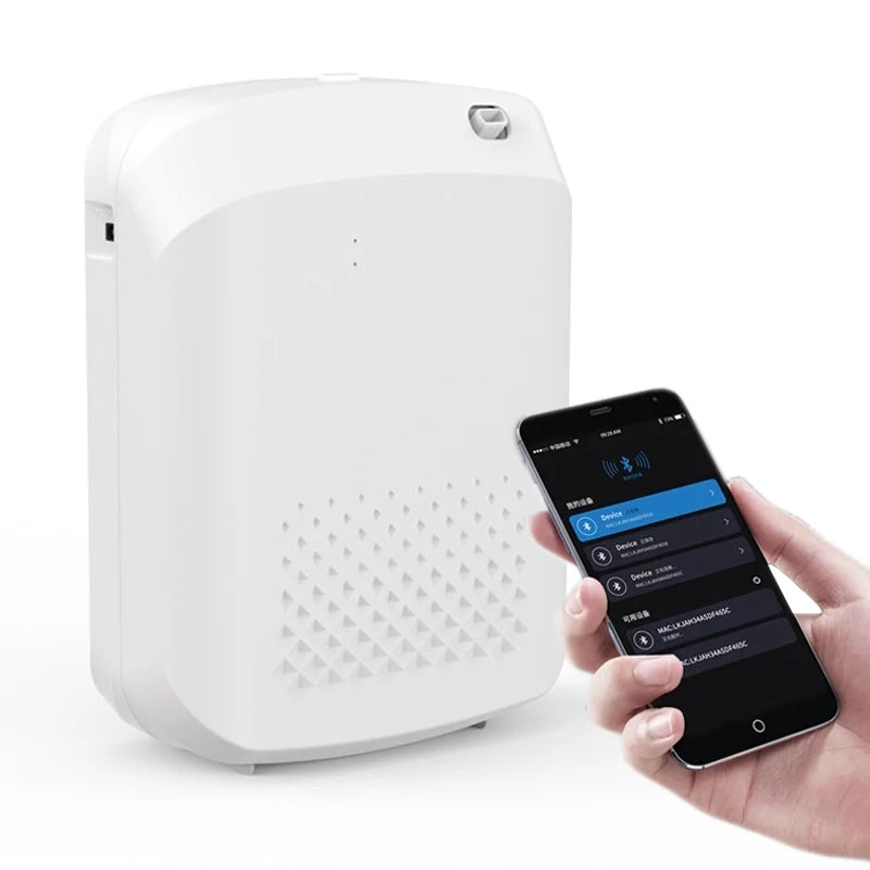 White electronic aromatherapy device next to a smartphone with an app interface on a white background