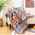 Coral Zigzag Aztec throw blanket on a cream sofa with woven basket nearby