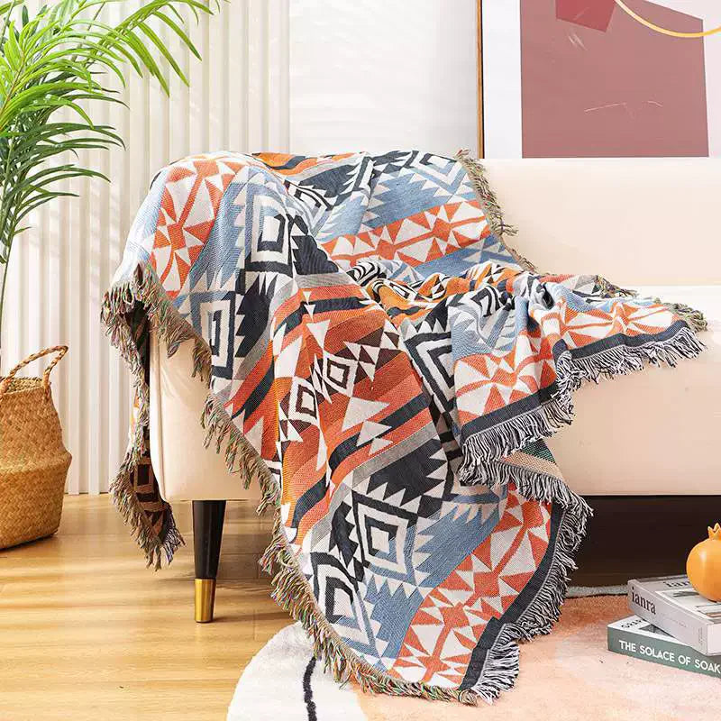 Coral Zigzag Aztec throw blanket on a cream sofa with woven basket nearby