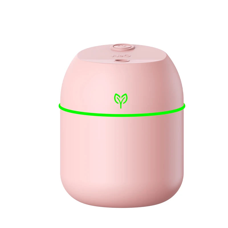 Pink humidifier with green light on a white background