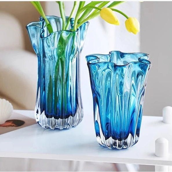 Two blue glass vases with greenery on a white surface, labeled 'Best living bedroom'.