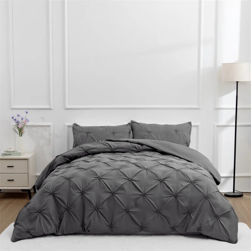 Charcoal pintuck duvet set with matching pillowcases dressed on a double bed in a clean modern bedroom