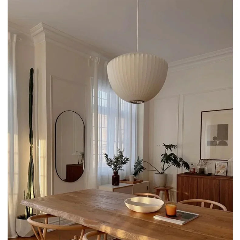 White Wabi Sabi pendant lamp hanging above a styled dining display