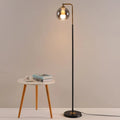 Black stem brass globe floor lamp in a neutral minimalist setting