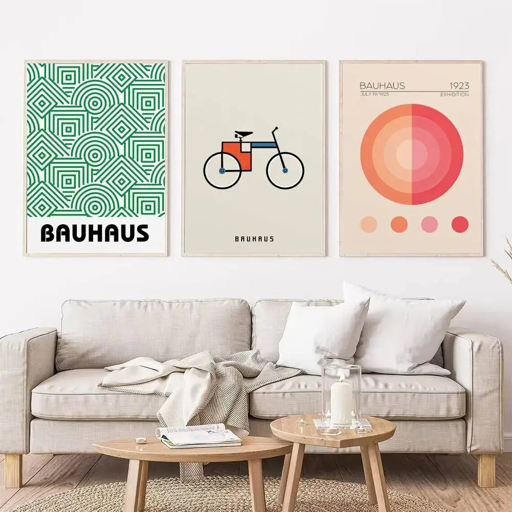 Living room with a beige sofa, coffee table, and three Bauhaus-style posters on the wall.