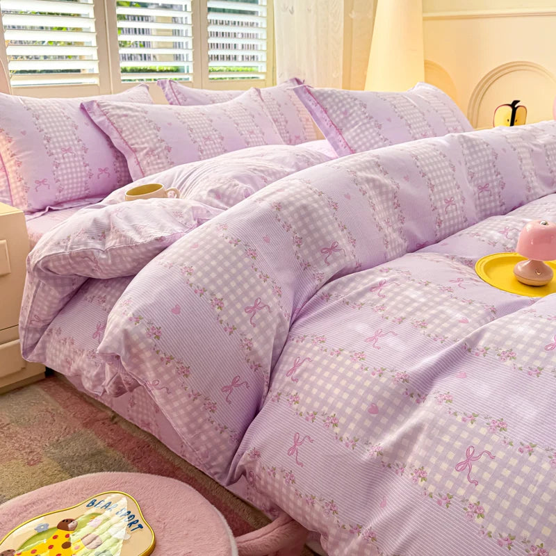 Close-up of Purple Gingham cotton duvet cover featuring lavender checks, pink bows, and floral borders.