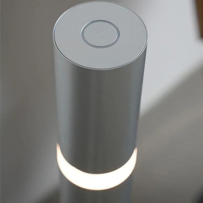 Detailed view of the integrated touch switch on top of the aluminium floor lamp.