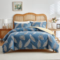 Blue duvet cover set with beige tropical leaf pattern and matching pillowcases
