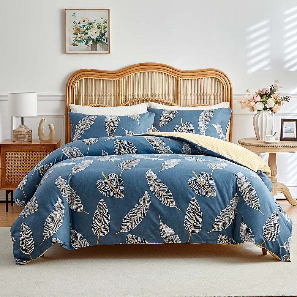 Blue duvet cover set with beige tropical leaf pattern and matching pillowcases