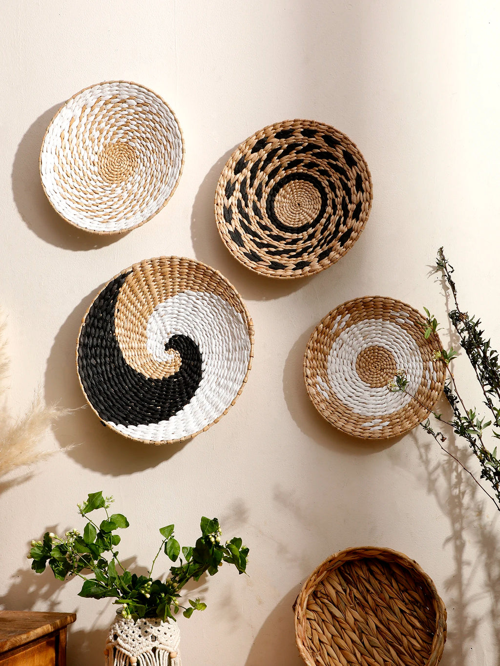 Woven baskets of various designs on a light background with plants.