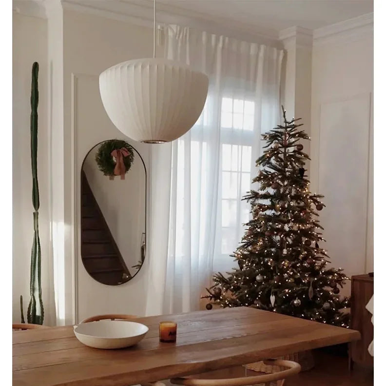 White Wabi Sabi pendant lamp hanging above a styled dining display