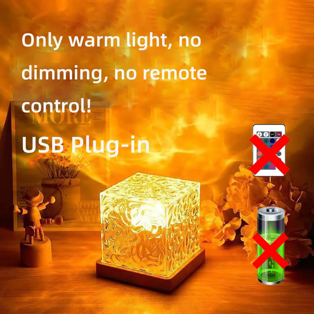 USB plug-in light cube with warm glow on a wooden surface, surrounded by decorative items.