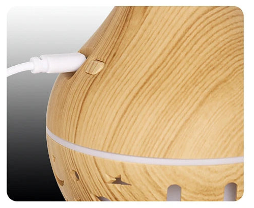 Wooden diffuser with a white cord on a gradient background