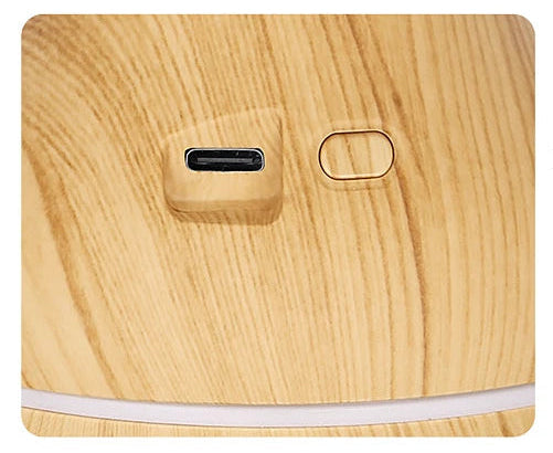 Wooden device with USB-C port and power button on a light wood background