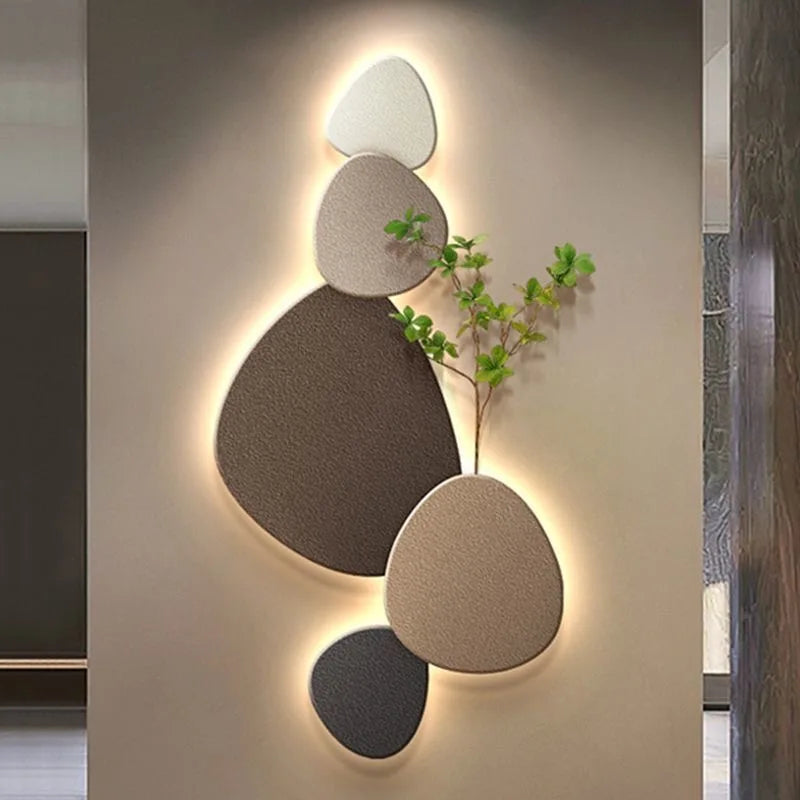 Neutral stone decorative LED wall light with organic shapes, plant detail, and warm ambient glow