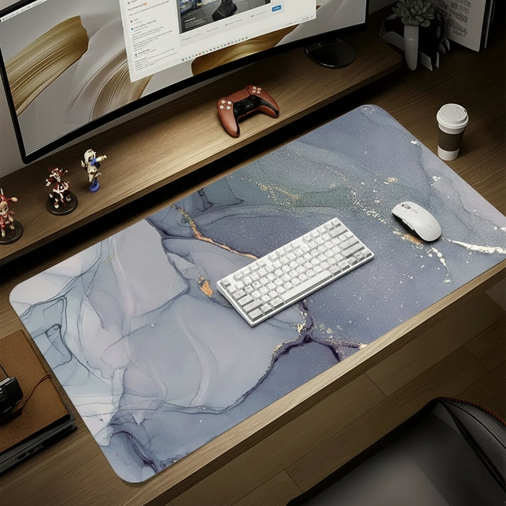 Desk setup with a large mouse pad, keyboard, and computer monitor on a wooden desk.