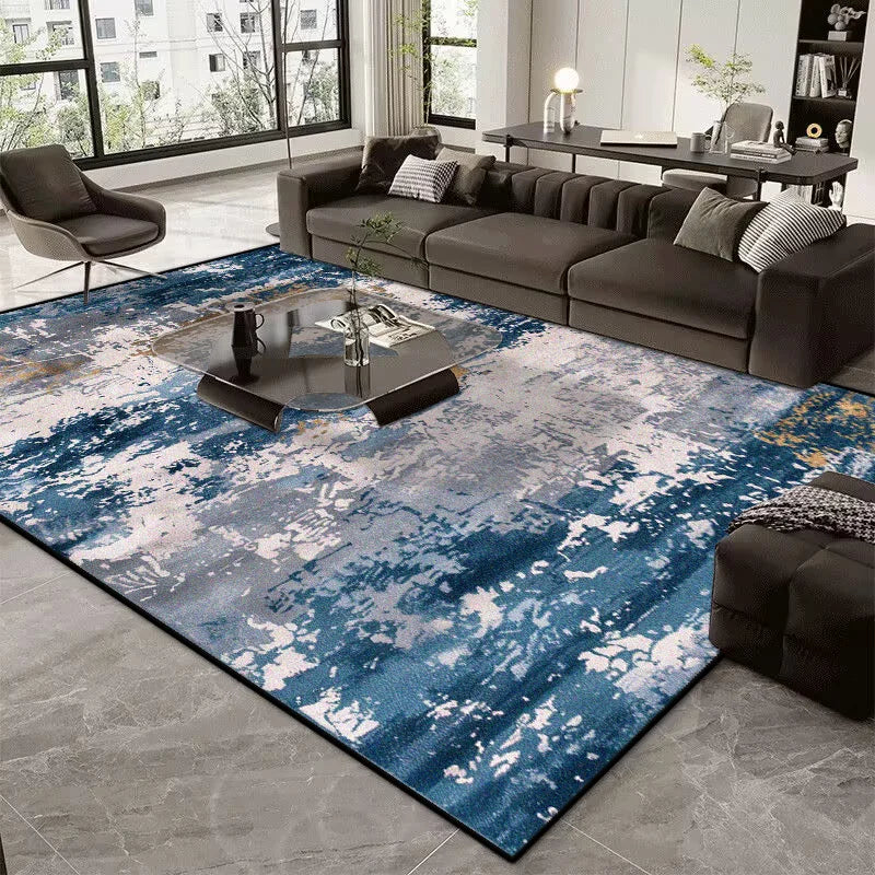 Living room with a blue and gray patterned rug, dark sofa, and coffee table.
