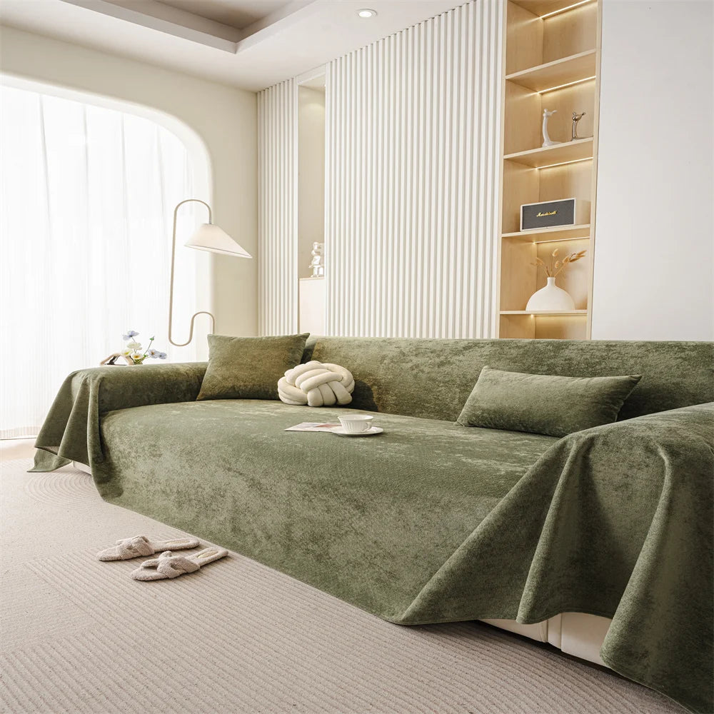 Soft-touch olive sofa throw styled in a minimalist living room