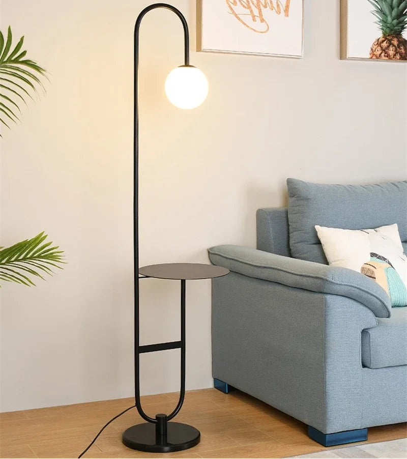 A black floor lamp beside the sofa