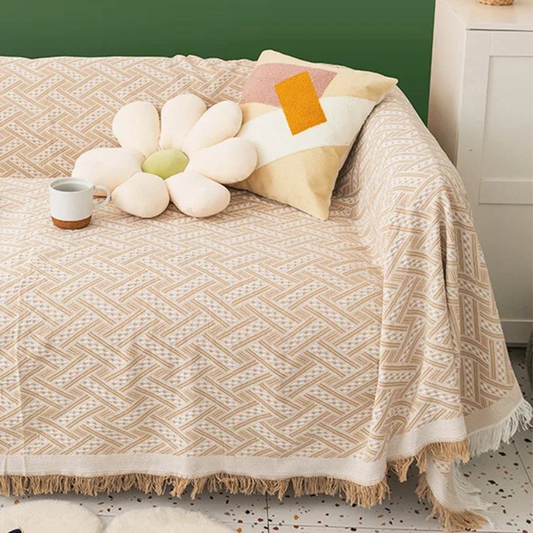A warm ivory textured sofa cover on a couch with decorative pillows and a mug.