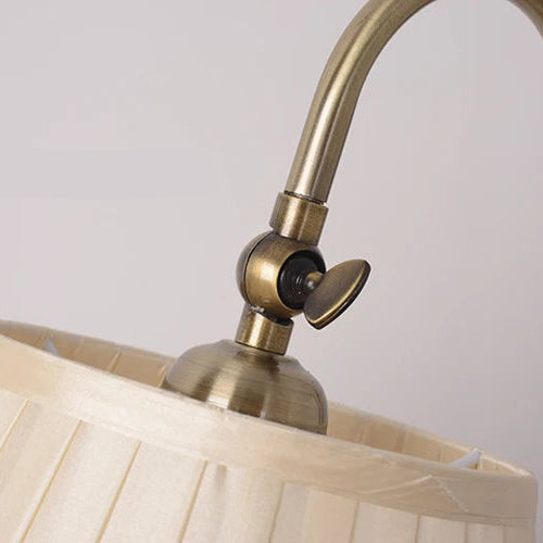 Close-up of adjustable lamp head joint above fabric shade.