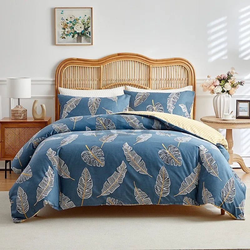 Blue duvet cover set with beige tropical leaf pattern and matching pillowcases