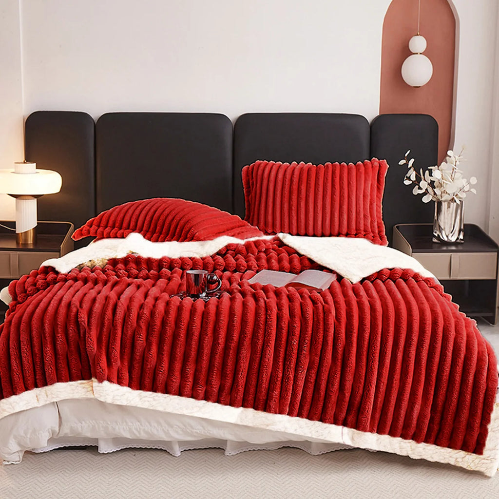 A deep red textured blanket on a bed in a bedroom setting