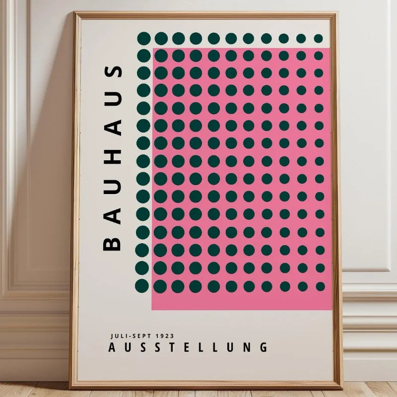 Bauhaus abstract dot print with dark green circles over a pink grid layout on a neutral background