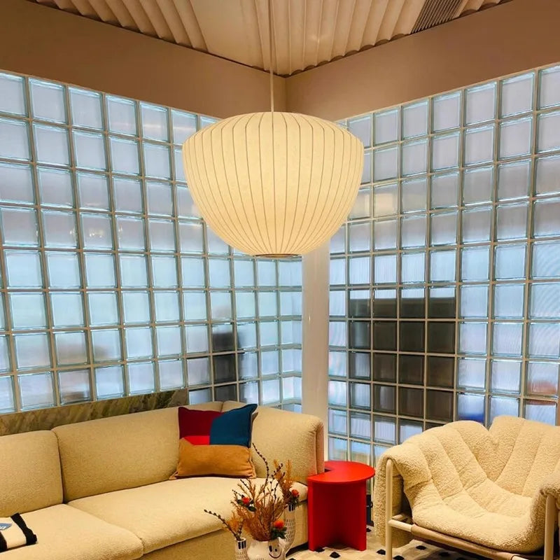 Warm glowing silk pendant lamp in a modern lounge with glass block walls