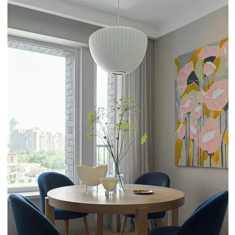 White Wabi Sabi pendant lamp hanging above a styled dining display