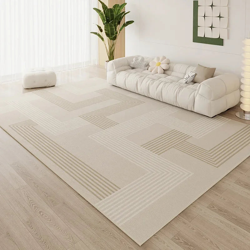 Large cream area rug with tonal geometric grid line pattern in a bright minimalist living room with white cloud sofa