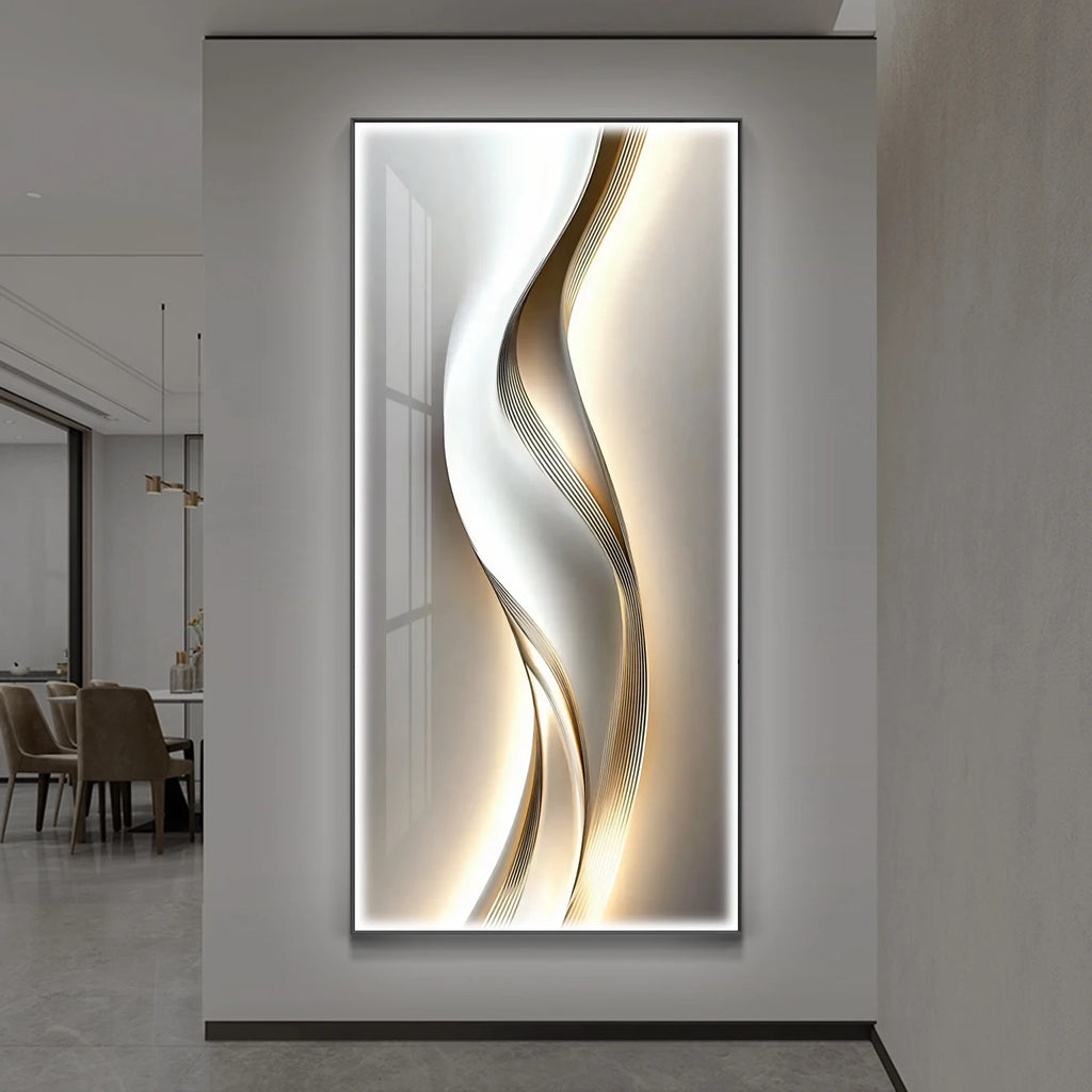 Gold and silver ribbon wave LED backlit wall panel glowing on a grey wall