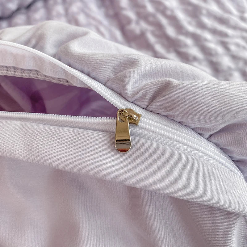 Close-up of hidden zip closure on ruffle duvet cover set in soft lavender