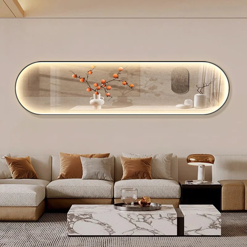 Oval-shaped LED wall art displaying a minimalist scene of a branch with orange persimmons and small white birds against a warm beige background, mounted above a contemporary beige sofa.
