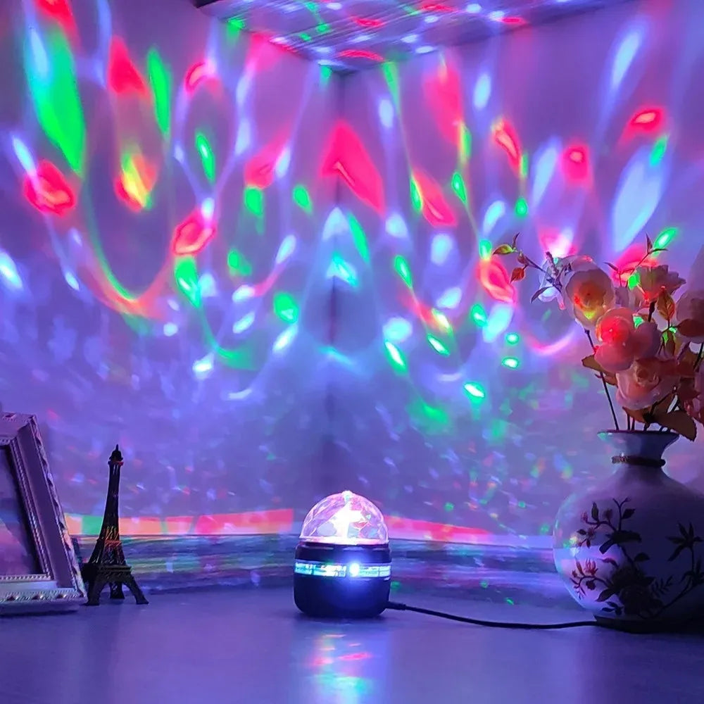 Colourful disco light projector on a table with decorative items in the background