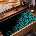 Black mouse pad with teal circuit-inspired geometric pattern