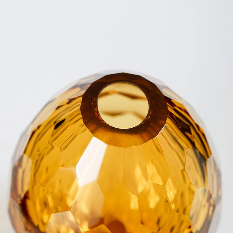 Top opening detail of an amber sculpted glass vase