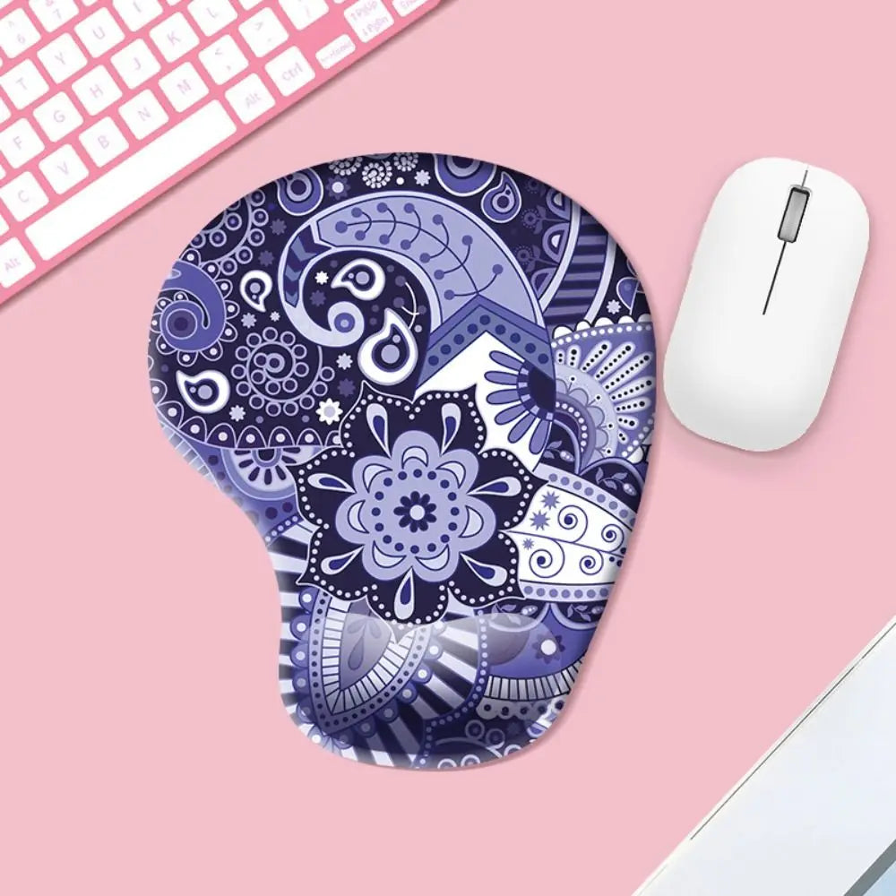 Decorative blue and white mouse pad on a pink surface with a computer mouse.