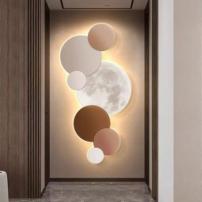Warm beige and brown moon wall light glowing above a console table