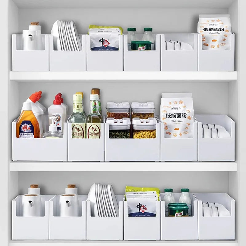 White kitchen shelves with various items including bottles, containers, and boxes.