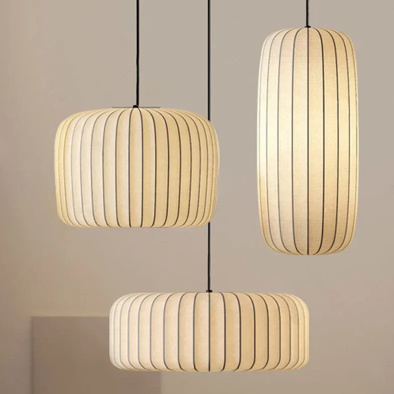 Three pendant lights hang against a neutral background