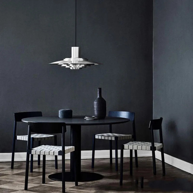 Silver aluminium pendant light styled above a modern interior setting