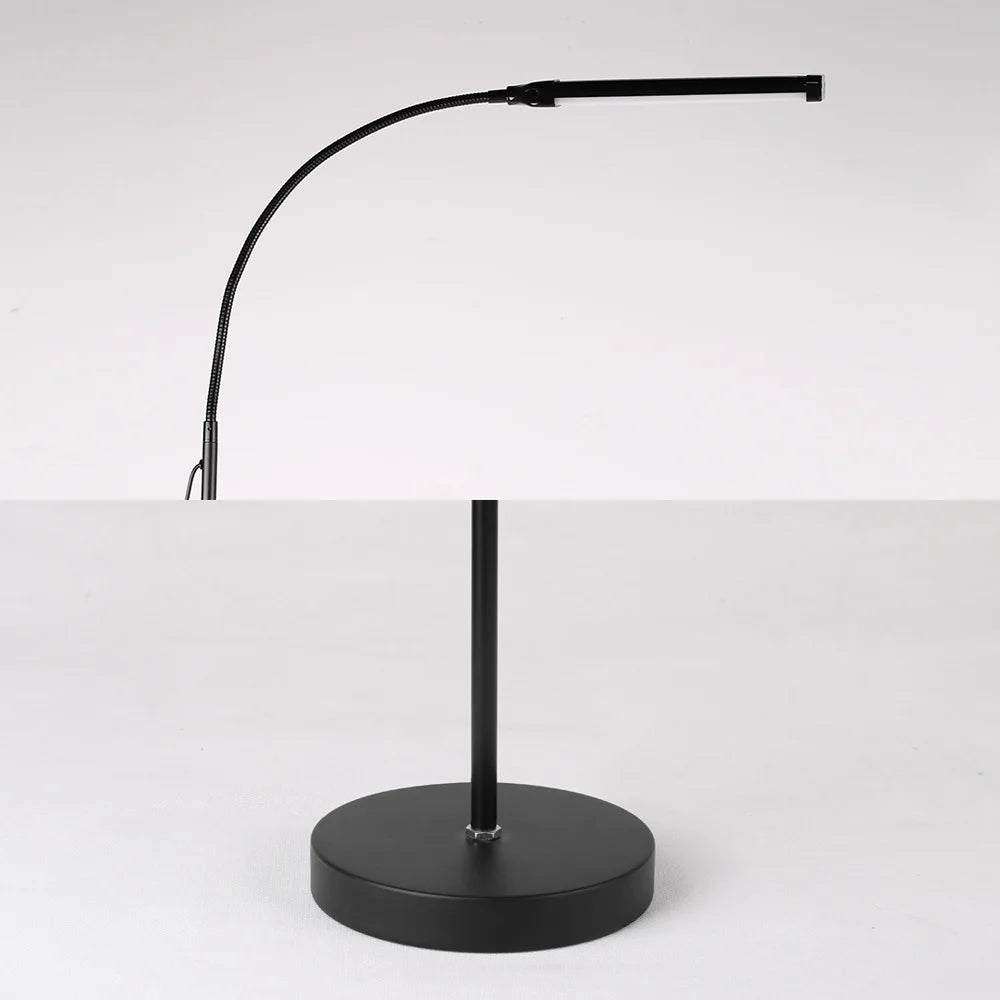Black adjustable desk lamp on a white background