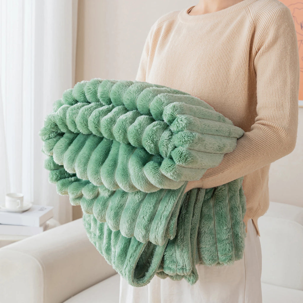 Person holding a green textured pillow in a home setting