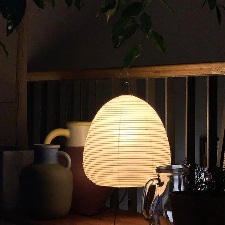 Woven lampshade on a wooden surface with a dark background