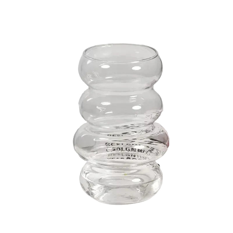 Clear glass vase with measurements on a light grey background