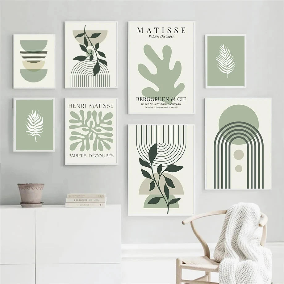 Set of green abstract and nature-themed wall art prints on a grey wall.