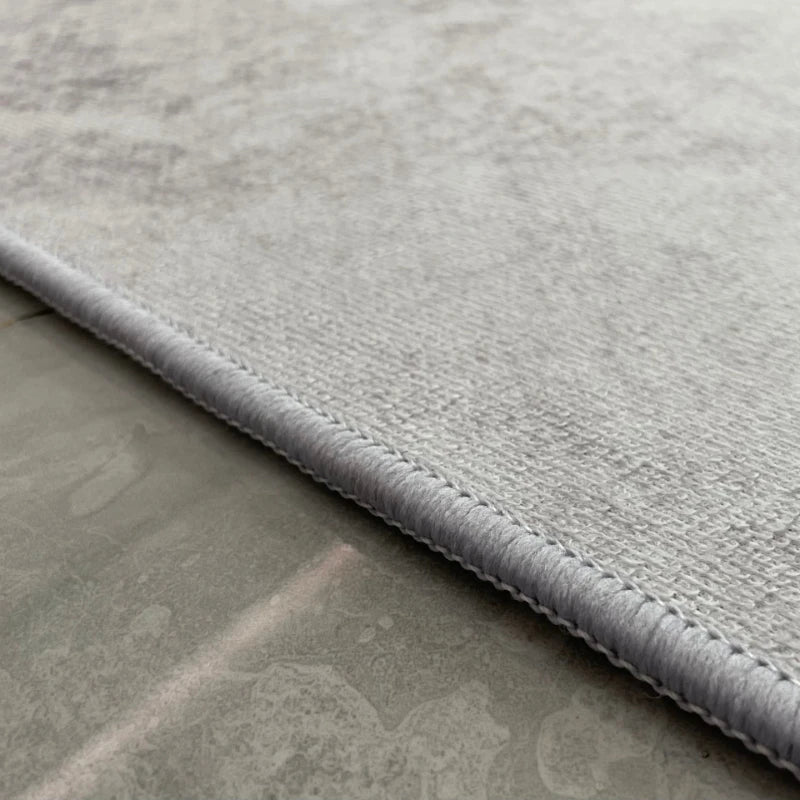 A close up of side view of 3D rug on a tiled floor