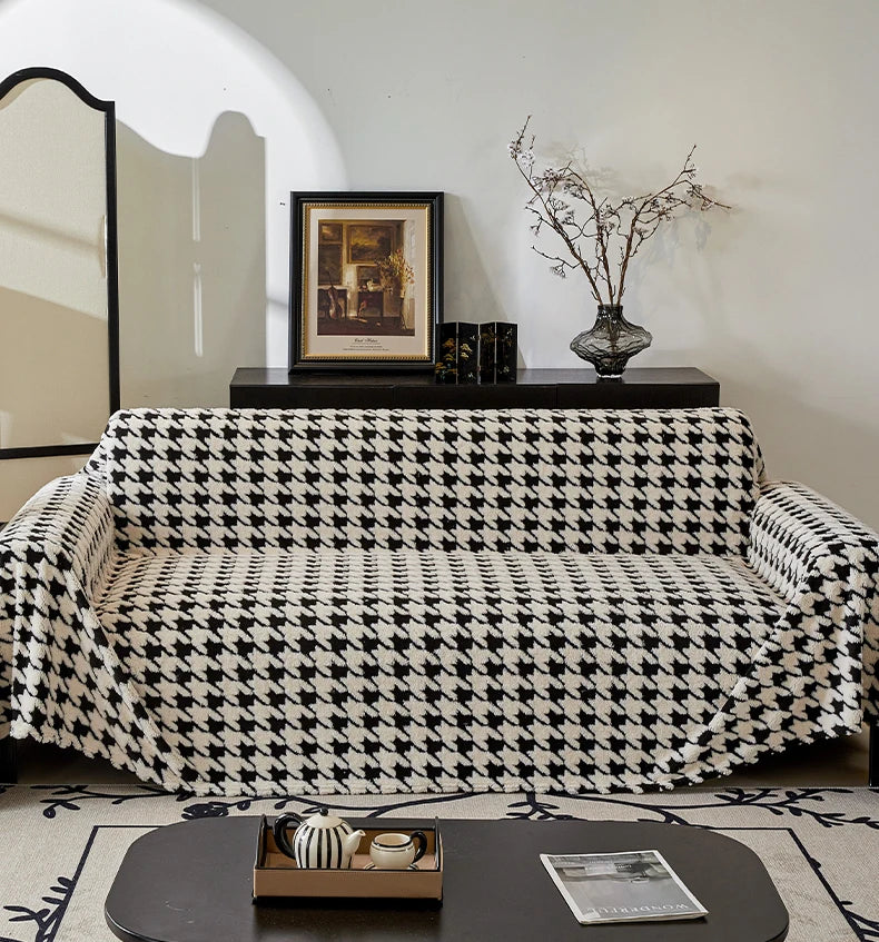 Sofa with a houndstooth pattern cover in a living room setting.