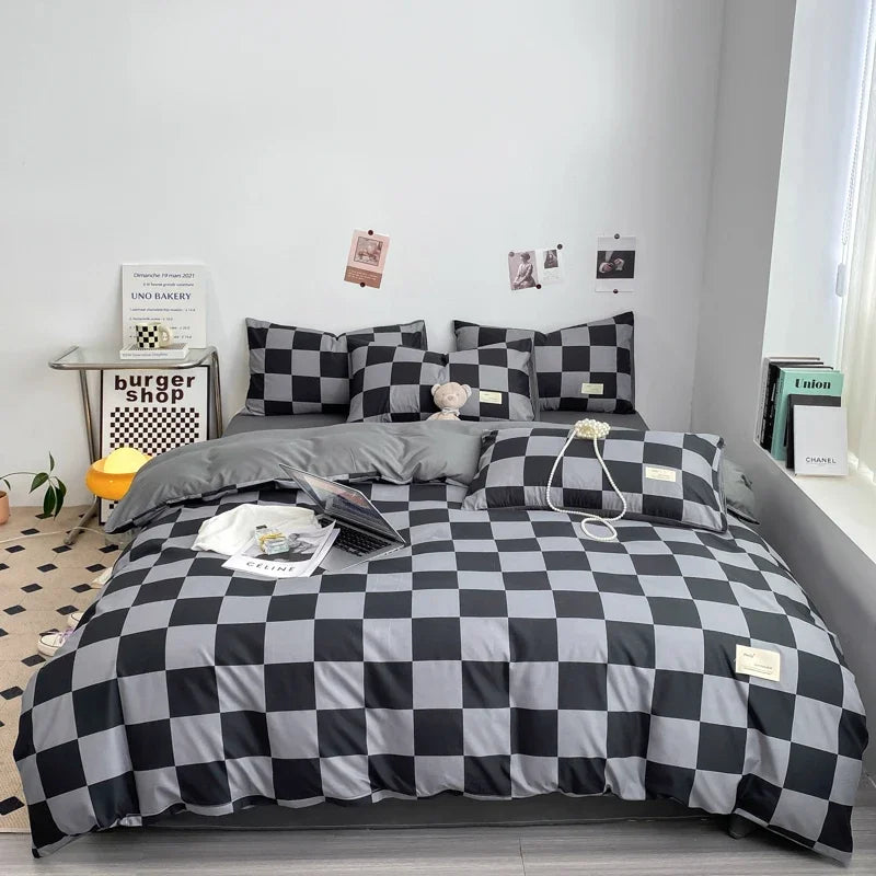 Black and grey checkerboard duvet cover set with matching pillowcases dressed on a double bed in a modern styled bedroom